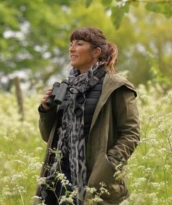 Lucy-Cooke with binoculars on a wildlife adventure